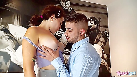 Busty brunette with a tattooed body in an amateur video