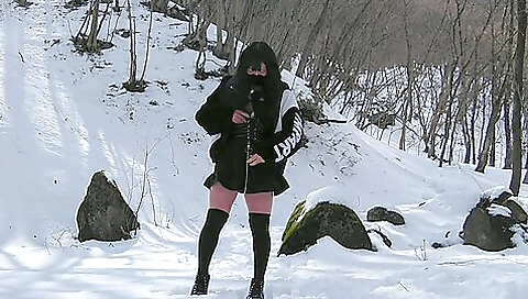 Asian brunette is naked in the snow and she shows her pussy